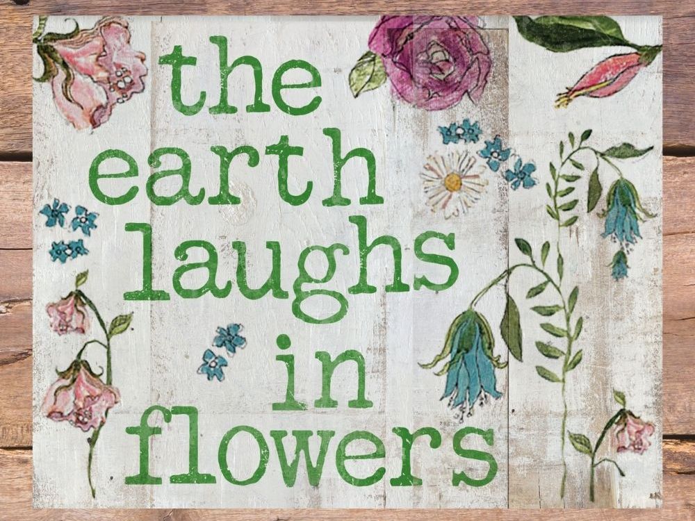 The Earth Laughs in Flowers farmhouse style sign.