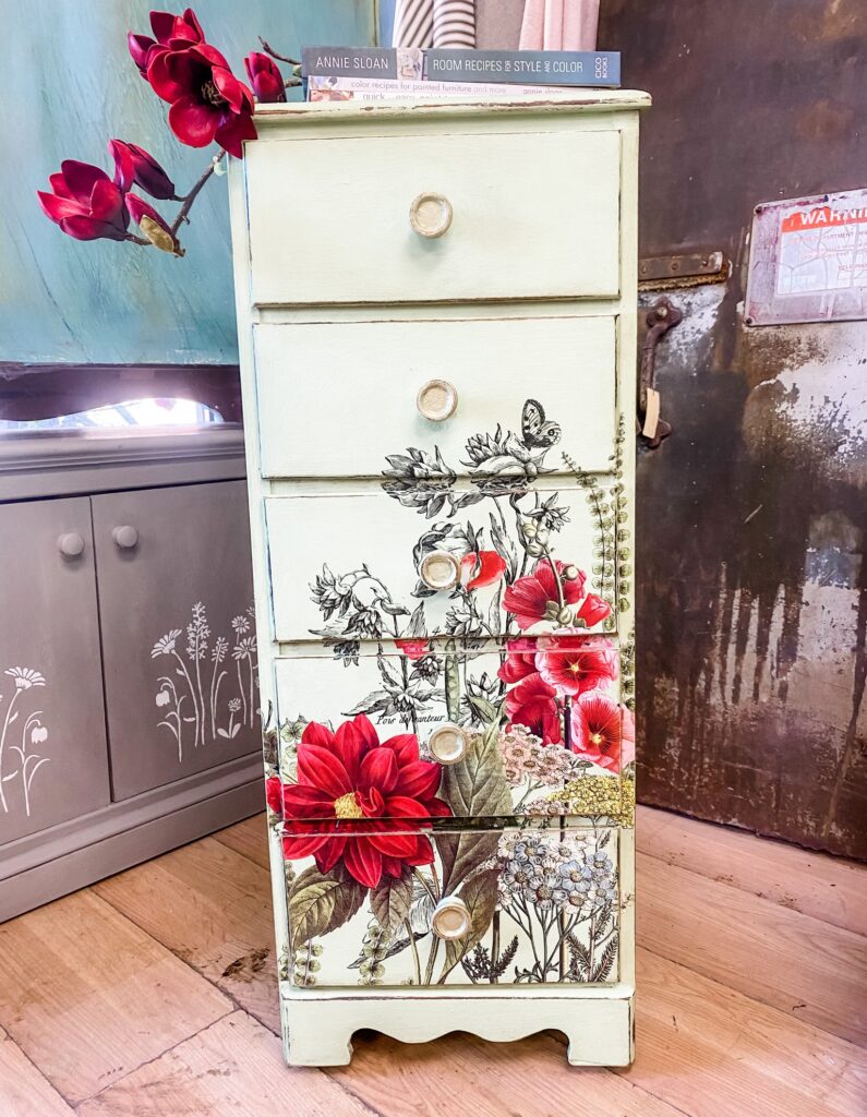 Small chest of drawers reminded in a cream white and red floral motif.
